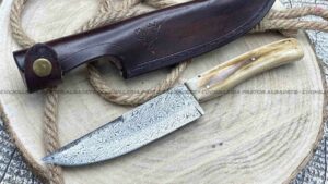 Cuchillo de lujo con hoja de acero damasco, empuñadura de mamut y funda de cuero de alta calidad.